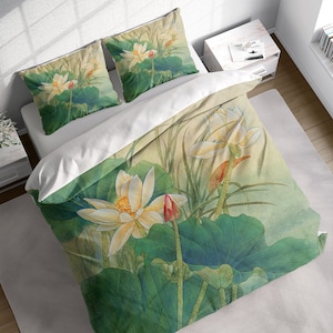May include: A white duvet cover with a green and white floral pattern featuring lotus flowers and leaves. The duvet cover is made of soft, breathable fabric and is perfect for adding a touch of elegance to any bedroom.
