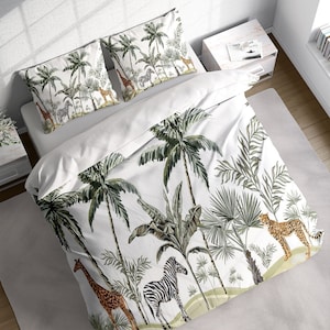 May include: White bedding with a tropical jungle print featuring palm trees, banana leaves, and animal silhouettes. The animals include a zebra, giraffe, and leopard.