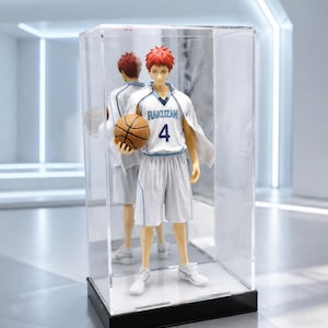 May include: A collectible anime figure of a basketball player with red hair, wearing a white jersey with the text RAKUZAN and the number 4, holding a brown basketball. The figure is displayed inside a clear rectangular acrylic display case.