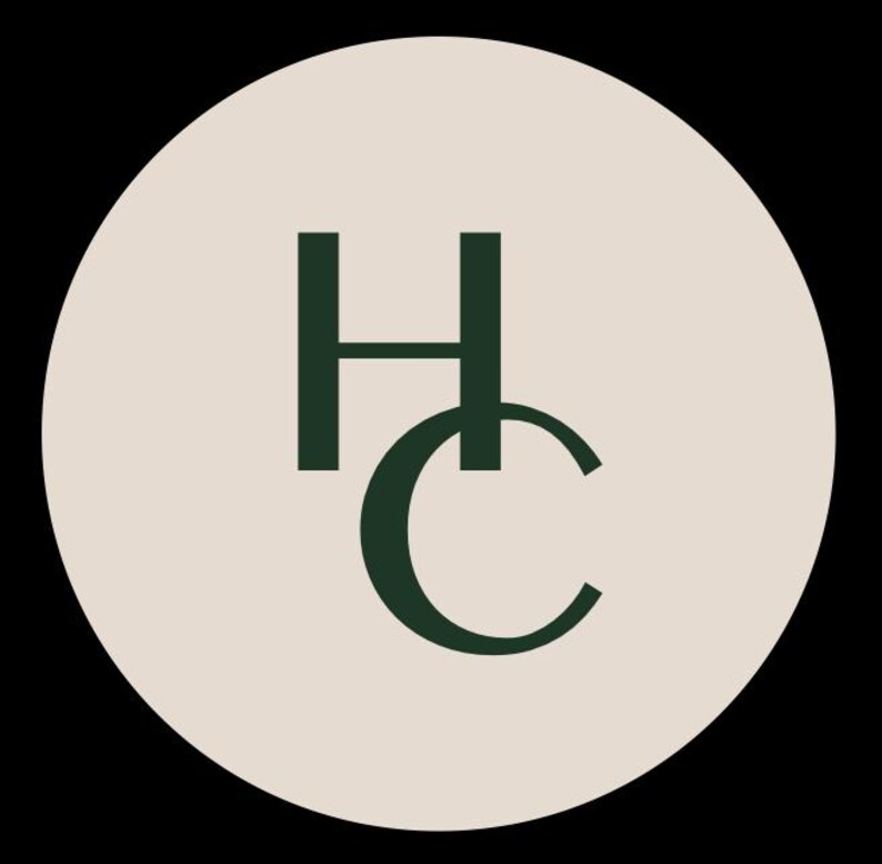May include: A circular logo featuring a light beige background with the dark green capital letters H and C stacked vertically. The letter H is positioned above the letter C, and both characters are rendered in a clean, sans-serif typeface.