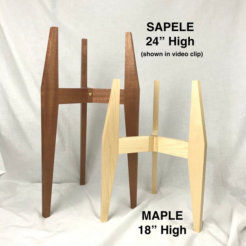 May include: Two plant stands, one made of maple wood and one made of sapele wood. The maple stand is 18 inches tall and the sapele stand is 24 inches tall.  "SAPELE 24" High (shown in video clip)" and "MAPLE 18" High" are written on the stands.