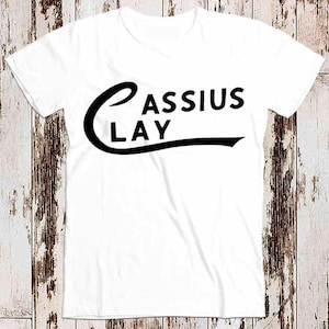 May include: White t-shirt with black text that reads "CASSIUS CLAY" in a curved font.