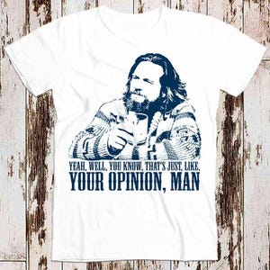 May include: White t-shirt with a blue and white image of a man with a beard and long hair. The text "YEAH, WELL, YOU KNOW, THAT'S JUST, LIKE, YOUR OPINION, MAN" is printed in blue below the image.