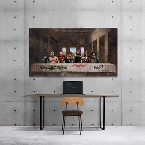 May include: A large canvas print parodying The Last Supper, featuring modern characters in place of the original figures. The table is tagged with graffiti reading "THE LAST CRYPTX" and other symbols. The print hangs on a concrete wall above a desk with a laptop and chair.