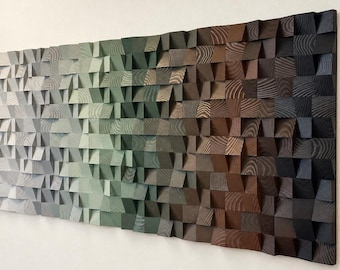 May include: A rectangular wall art piece composed of numerous small, individual wooden blocks of varying depths. The blocks are arranged in a gradient color pattern, transitioning from white on the left to shades of gray, green, brown, and black on the right.