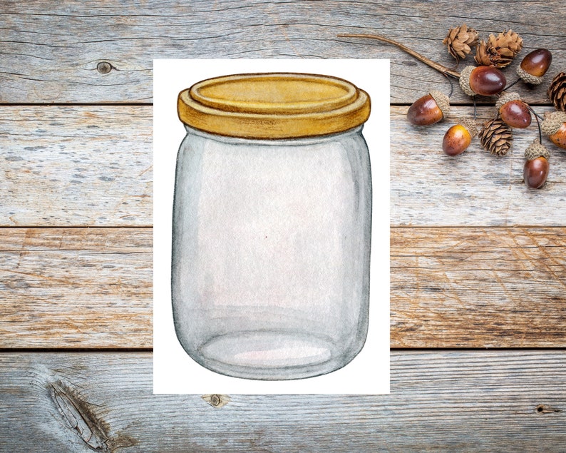 May include: A clear glass jar with a golden lid. The jar is empty and has a slightly textured surface. The jar is sitting on a white background.