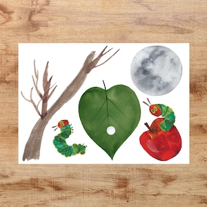 May include: A watercolor illustration of a green leaf with a white circle in the center, a gray moon, a brown branch, and two green caterpillars with red heads. One caterpillar is eating a red apple.