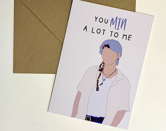Op de afbeelding: Een witte kaart met een cartoonillustratie van een persoon met paars haar, die een wit shirt en een kleurrijk bandana draagt. De tekst op de kaart luidt "Je betekent veel voor me."