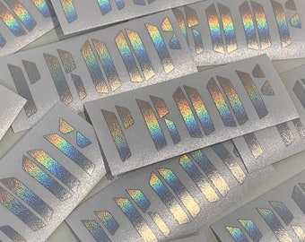 May include: Multiple iridescent silver stickers with the word "PROUD" printed on them.