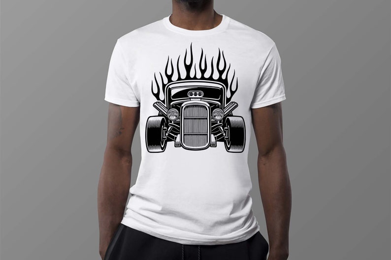 May include: A white t-shirt with a black and white illustration of a hot rod car with flames. The car has a grill, headlights, and a hood scoop.