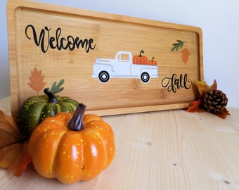 Decorative autumn centerpiece tray in hand-painted wood with pumpkins, leaves, and a farmer's truck. Welcome autumn!