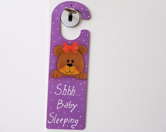 Wooden hanger for a newborn baby boy or girl's bedroom door handle with a hand-painted teddy bear