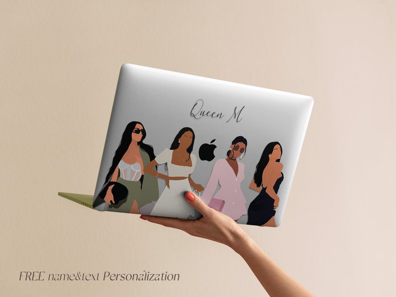 May include: A white laptop with a design featuring four women in different outfits and the text "Queen M".