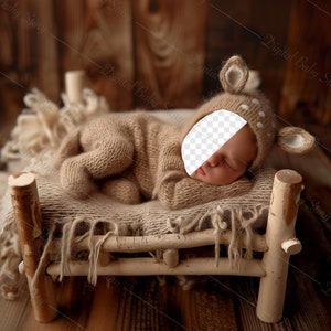 May include: A newborn baby wearing a brown knitted deer costume sleeps in a wooden crib with a brown knitted blanket.