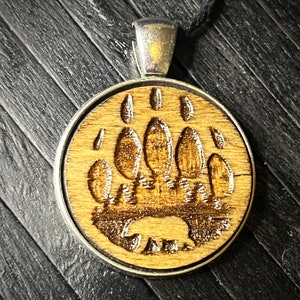 The wild engraved wood charm cord necklace..
