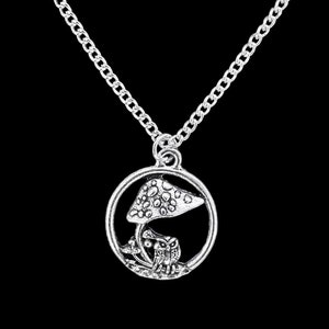 May include: A silver necklace with a circular pendant featuring a mushroom and an owl. The pendant is detailed with a textured mushroom cap and a small owl perched on the stem.