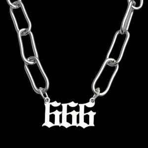 May include: A silver chain necklace with a silver pendant featuring the number 666 in a gothic font.