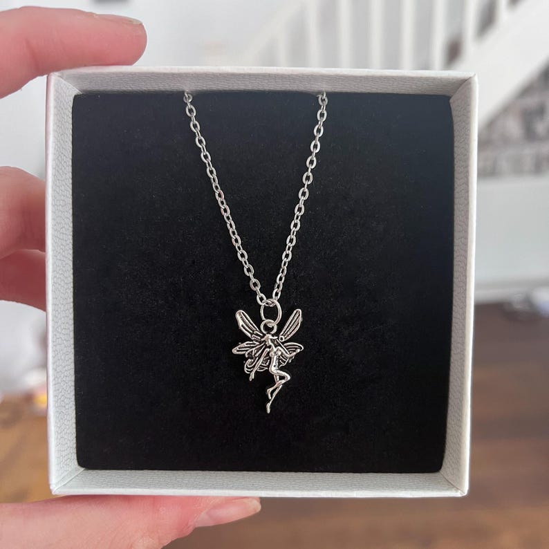 The silver fairy necklace is perfect for those who love fairycore and cottagecore style jewellery. The necklace is photographed here inside of a black box.