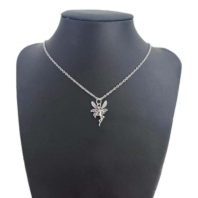 Another image of the fairy necklace placed against a black necklace display model.