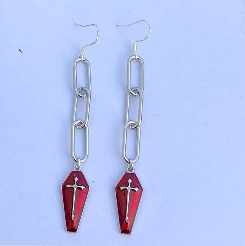 The coffin charms dangle from the centre of the last silver chain link. The earrings are quite long. Please see the item description for exact measurements of these earrings.