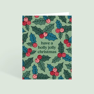 Ayez une carte de voeux de Noël Holly Jolly avec enveloppe | Blanc à l'intérieur | Carte de Noël souriante mignonne de Zazzle.be Liste d'envies Vous avez des idées ? Joyeux Noël | Regroupez et économisez