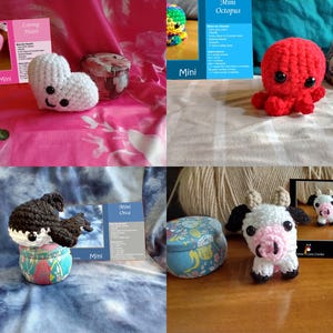 May include: A collection of handmade crochet mini-animals, including a red octopus, a black and white orca, a white and black cow, and two crochet hearts. Each animal is displayed with a decorative tin and a small information card.