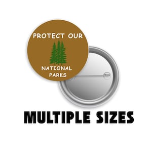 May include: A round button with the text "PROTECT OUR NATIONAL PARKS" in white on a brown background, with a green tree graphic. The button is next to a silver pinback. The words "MULTIPLE SIZES" are below the button.