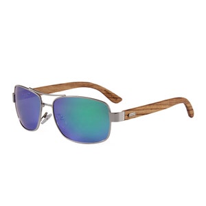 May include: Silver aviator sunglasses with green and blue mirrored lenses and a wooden frame. The frame is labeled "HANDMADE".