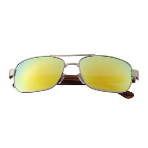 May include: Aviator-style sunglasses with a silver metal frame and mirrored yellow lenses. The temples are made of dark wood. The sunglasses have a double bridge and a classic, timeless design.