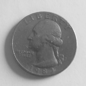 May include: A United States quarter coin, featuring a profile of a person and the word "LIBERTY" at the top. The words "IN GOD WE TRUST" and the year "1981" are also visible. The coin is silver in color.