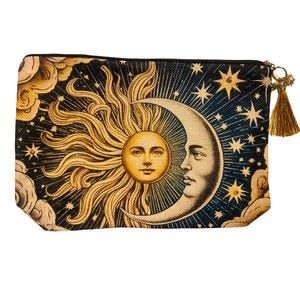 May include: A rectangular cosmetic bag featuring a celestial design. The bag showcases a sun and moon with faces, surrounded by stars and clouds against a dark blue background. A gold tassel hangs from the zipper.