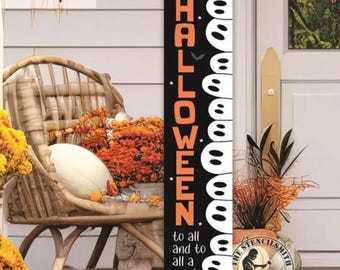 May include: A black and white Halloween-themed wooden sign. The sign features the words "happy HALLOWEEN" in orange and white ghost designs. The bottom of the sign reads "to all and to all a good fright".