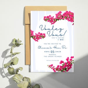 May include: A wedding invitation with the text "Voulez Vous!" and "She's saying I do!" in navy blue script. The invitation is decorated with pink bougainvillea flowers and includes details for Olivia's Hen Do in Rhodes, Greece, August 5, 2026.
