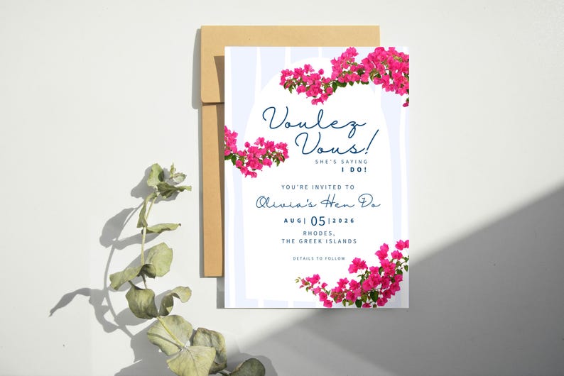 May include: A wedding invitation with the text "Voulez Vous!" and "She's saying I do!" in navy blue script. The invitation is decorated with pink bougainvillea flowers and includes details for Olivia's Hen Do in Rhodes, Greece, August 5, 2026.