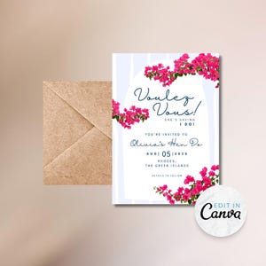 May include: A wedding invitation with the text "Voulez Vous!" and "Olivia's Hen Do" in a script font. The invitation features pink flowers and is set against a light blue striped background. A brown envelope is on the left.