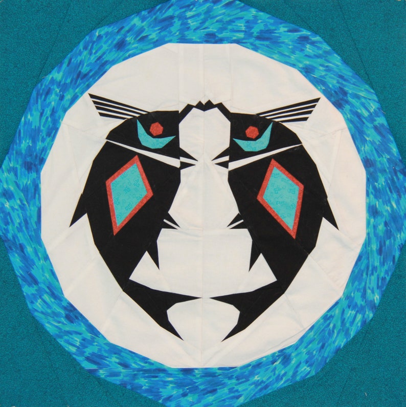 May include: A white circle with a blue and white patterned border. Inside the circle are two black fish facing each other with red and turquoise accents.