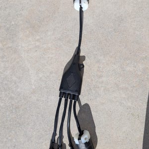 May include: A black electrical adapter with four outlets. The adapter has a single male plug on one end and four female plugs on the other end.
