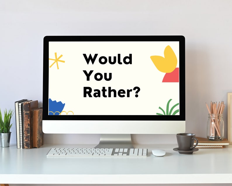 May include: A computer screen displaying the text "Would You Rather?" with colorful abstract shapes on a white background. The computer is on a white desk with a keyboard, mouse, and a cup of coffee.