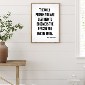 A minimalistic quote art print hangs on a wall. This motivational quote by Ralph Waldo Emerson adds to the decor in the home office.