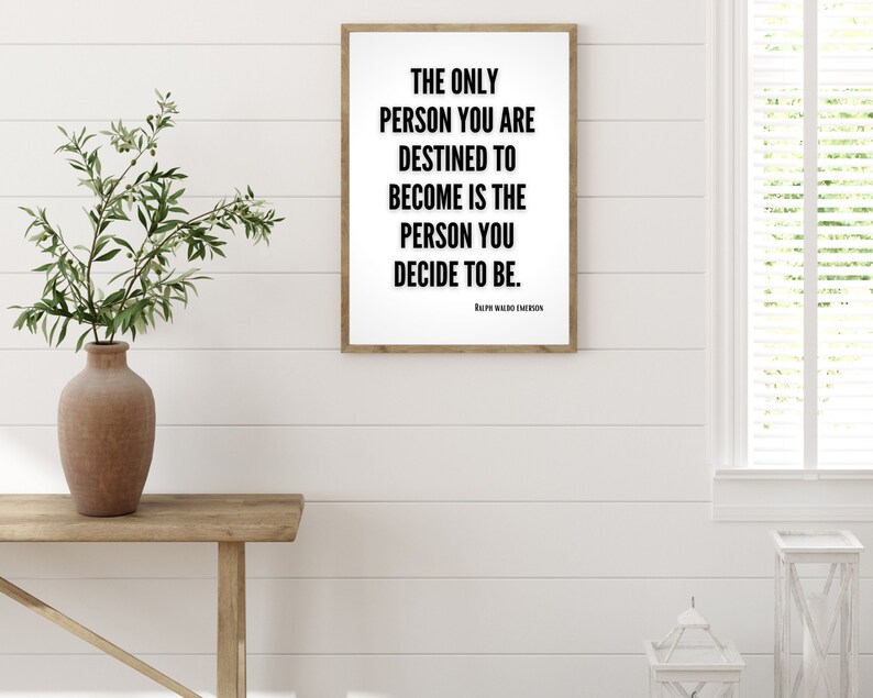 A minimalistic quote art print hangs on a wall. This motivational quote by Ralph Waldo Emerson adds to the decor in the home office.