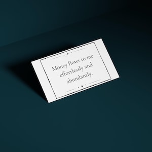 A money mantra card is shown against a deep teal background.
