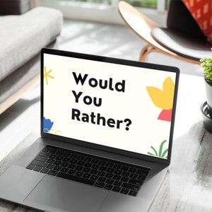 May include: A laptop computer with a white screen displaying the text "Would You Rather?" in black font. The screen also has colorful abstract shapes and a green plant graphic.