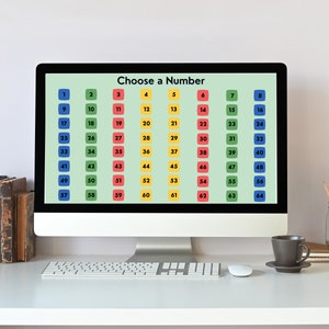 May include: A computer screen displaying a grid of numbers from 1 to 64, with each number in a colored square. The screen reads "Choose a Number". The computer is on a white desk with a keyboard, mouse, and a cup of coffee.