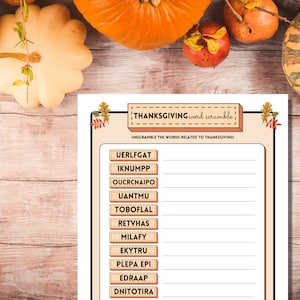 Downloadable Thanksgiving Word Scramble game is shown on a light wooden table with pumpkins and fall fruit.