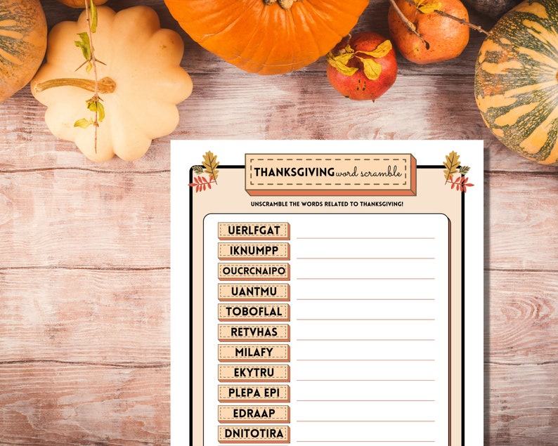 Downloadable Thanksgiving Word Scramble game is shown on a light wooden table with pumpkins and fall fruit.