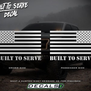 May include: A pair of white and black American flag decals. Each decal has the text "BUILT TO SERVE" and is labeled "DRIVER SIDE" and "PASSENGER SIDE". The decals are designed for vehicles.