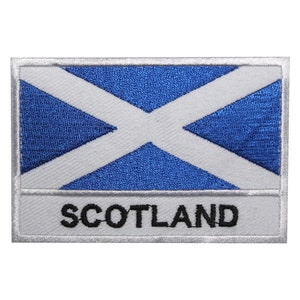May include: An embroidered patch featuring the Scottish flag in white and blue, with the word "SCOTLAND" in black lettering.
