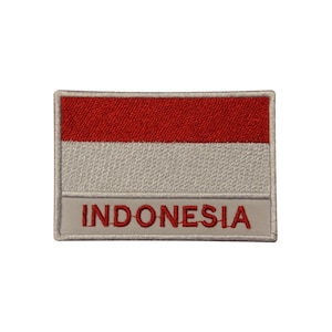 May include: An embroidered patch featuring the Indonesian flag with a red and white design. The patch has a white border and the word "INDONESIA" is written in red below the flag.
