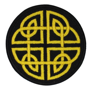 May include: A circular embroidered patch with a yellow Celtic knot design on a black background.