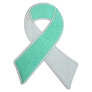 Peut inclure: Un ruban vert clair et blanc, symbole de sensibilisation et de soutien.